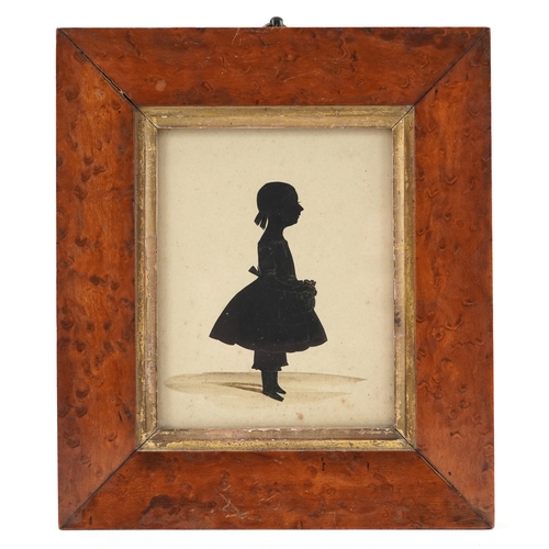 45 - A Georgian hand painted silhouette of a young female, within in a maple frame, 11cm x 9cm.