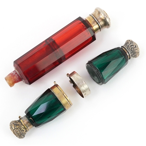 98 - Two Victorian double ended facetted glass scent bottles with white metal mounts, the largest 12cm in... 