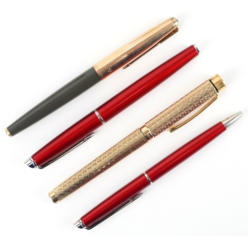 120 - A Sheaffer gold plated engine turned fountain pen with 14K gold nib, together with a Parker fountain... 