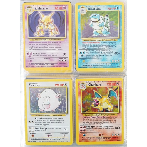 Pokémon, a full set of one hundred and two original base set Pokémon trade cards including first edition Machamp, housed in an album.