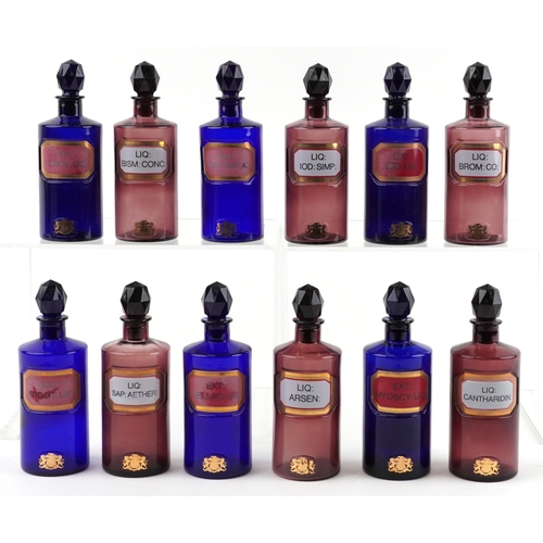 86 - A collection of Royal Pharmaceutical Society coloured glass chemist bottles with facetted stoppers, ... 