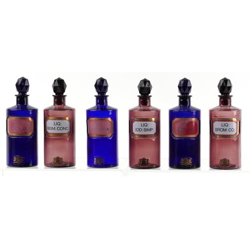 86 - A collection of Royal Pharmaceutical Society coloured glass chemist bottles with facetted stoppers, ... 
