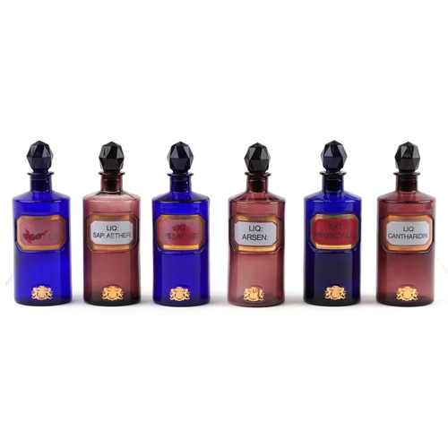 86 - A collection of Royal Pharmaceutical Society coloured glass chemist bottles with facetted stoppers, ... 