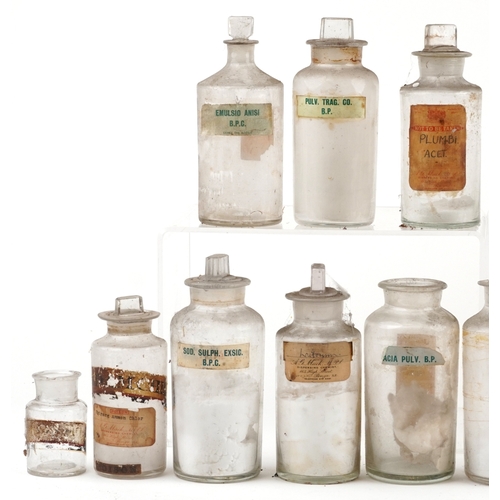 88 - A large collection of early 20th century pharmaceutical/apothecary glass jars, mostly with stoppers,... 