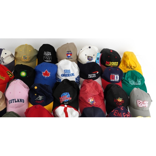 A large collection of vintage and later baseball caps, some advertising ...