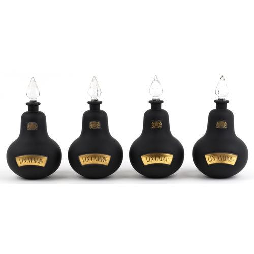 77 - A set of four Royal Pharmaceutical Society black frosted glass apothecary bottles with cut glass sto... 
