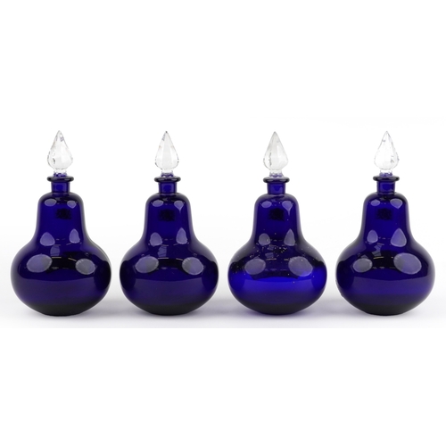 76 - A set of four Royal Pharmaceutical Society cobalt blue glass apothecary bottles with cut glass stopp... 