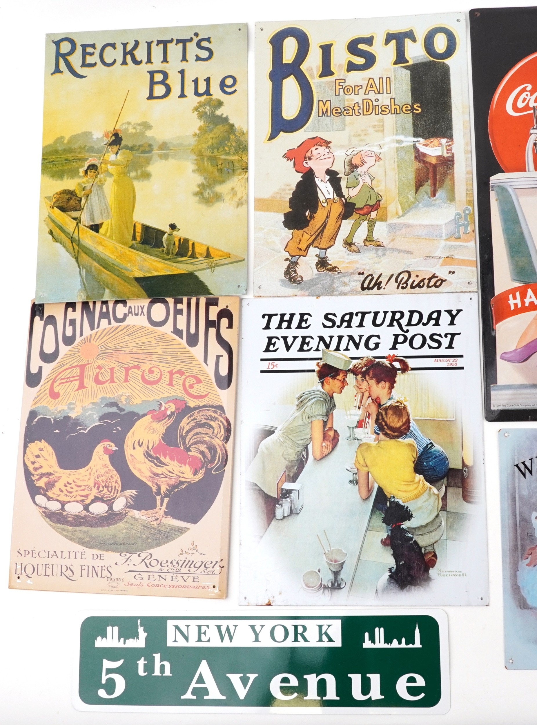 A large collection of reproduction advertising signs including Coca ...