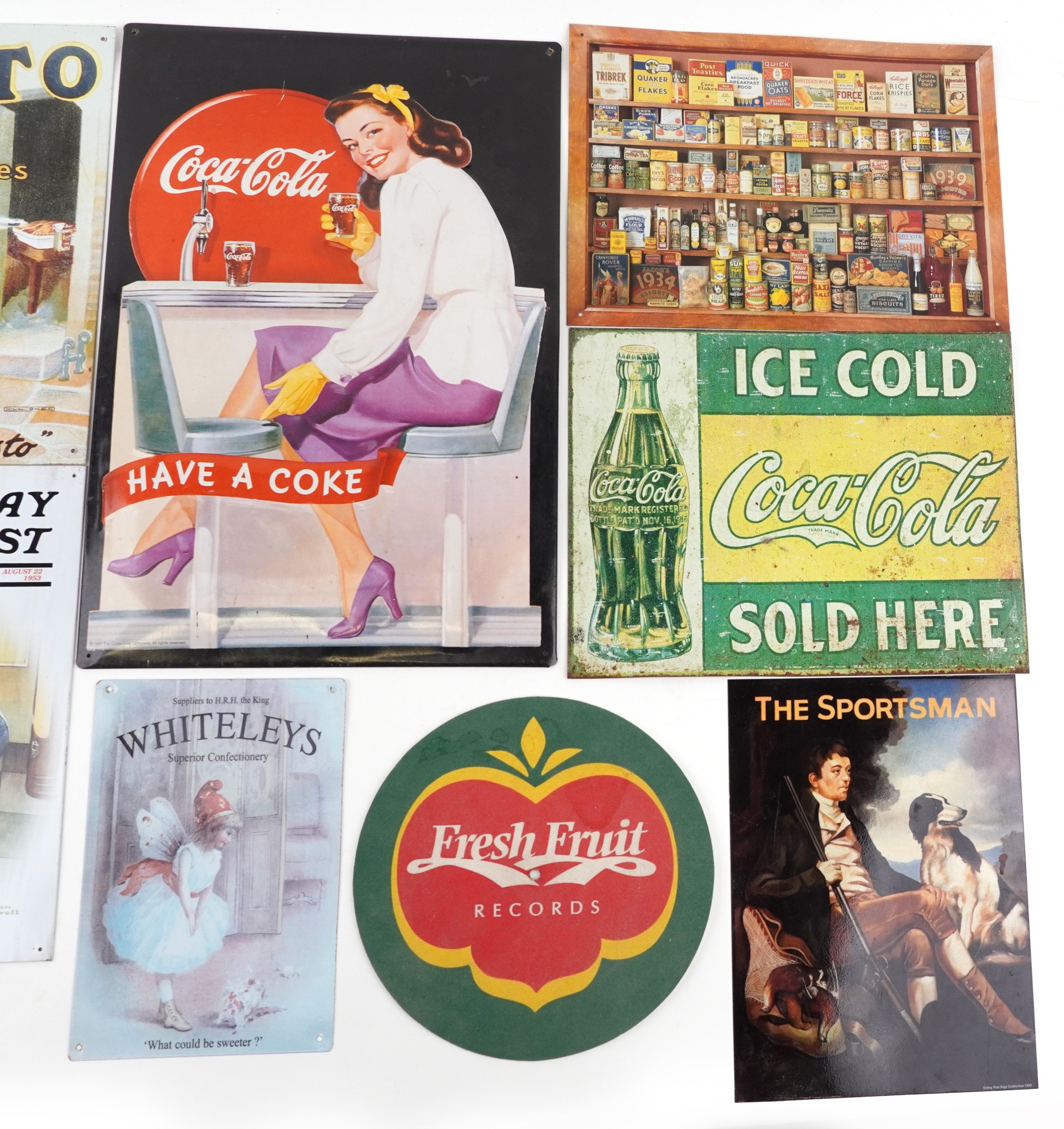 A large collection of reproduction advertising signs including Coca ...