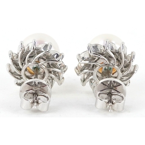  A 14K white gold cultured pearl and ruby ring with leaf design shoulders, size L, together with a pa... 