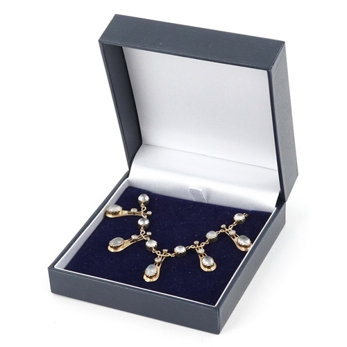  An Art Nouveau style 9ct gold diamond and moonstone fringe necklace, 44cm in length, 8.5g.