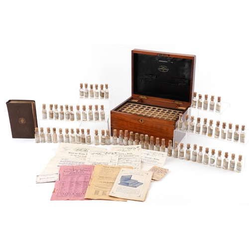 90 - A late George III mahogany apothecary cabinet housing a large collection of glass bottles with paper... 