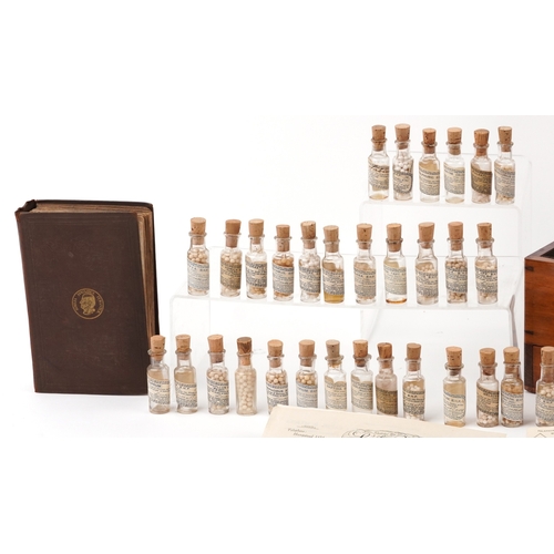 90 - A late George III mahogany apothecary cabinet housing a large collection of glass bottles with paper... 