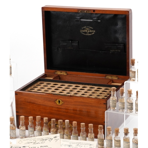 90 - A late George III mahogany apothecary cabinet housing a large collection of glass bottles with paper... 