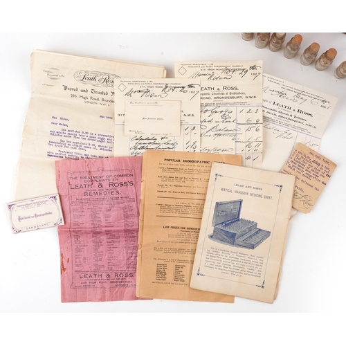 90 - A late George III mahogany apothecary cabinet housing a large collection of glass bottles with paper... 