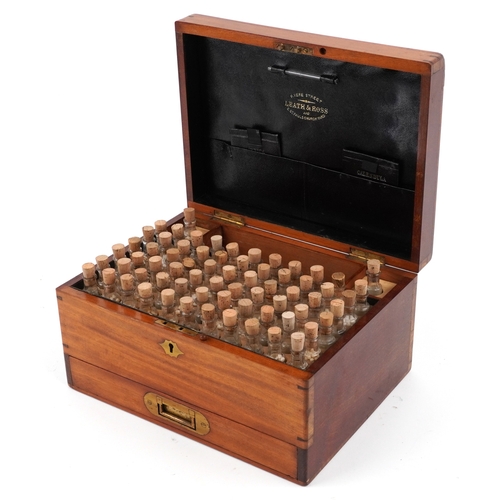 90 - A late George III mahogany apothecary cabinet housing a large collection of glass bottles with paper... 