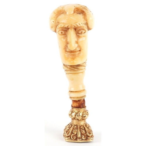 A 19th century unmarked gold citrine intaglio seal fob with bone handle carved in the form of The Duke of Wellington, 5.4cm high, 10.4g.