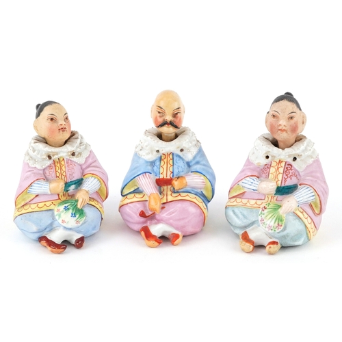 Three 19th century continental bisque Asian nodders, the largest 8cm high.