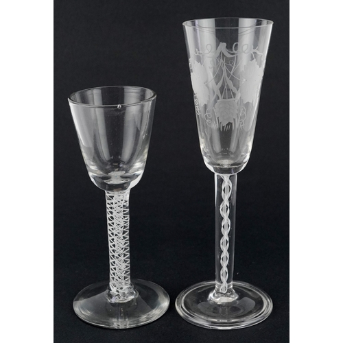 96 - Two 20th century wine glasses with air twist stems, one acid etched with vines, the largest 20cm hig... 
