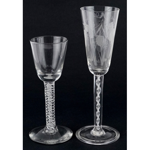 96 - Two 20th century wine glasses with air twist stems, one acid etched with vines, the largest 20cm hig... 