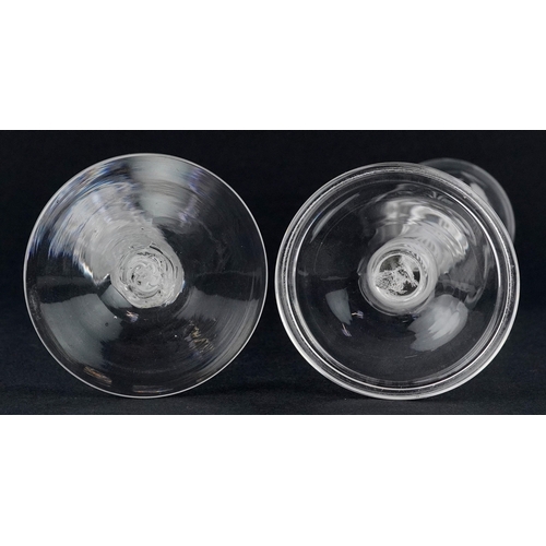 96 - Two 20th century wine glasses with air twist stems, one acid etched with vines, the largest 20cm hig... 