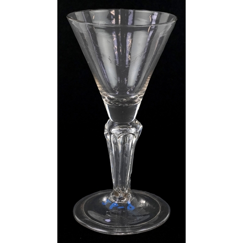 91 - An early 18th century wine glass with facetted stem, 15cm high.