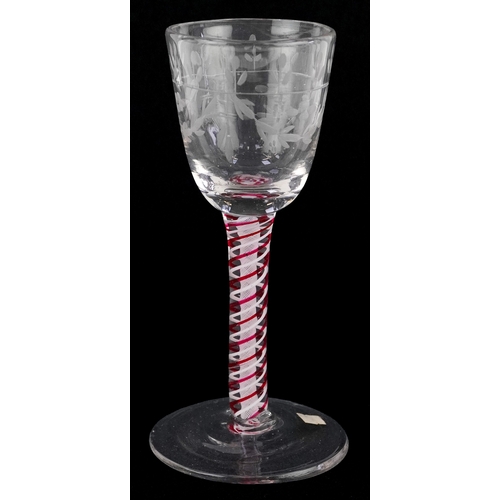 93 - An 18th century wine glass with red and white air twist stem and etched floral decoration, 13cm high... 