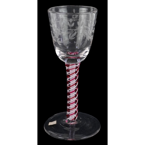 93 - An 18th century wine glass with red and white air twist stem and etched floral decoration, 13cm high... 