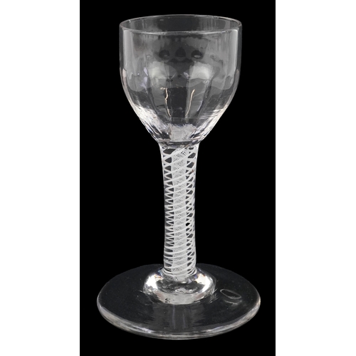 92 - An 18th century wine glass with fluted bowl and air twist stem, 13cm high.