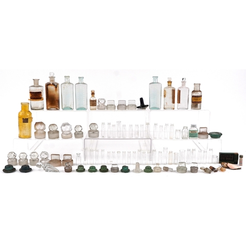 87 - A collection of early 20th century apothecary and pharmaceutical glass bottles together with decante... 