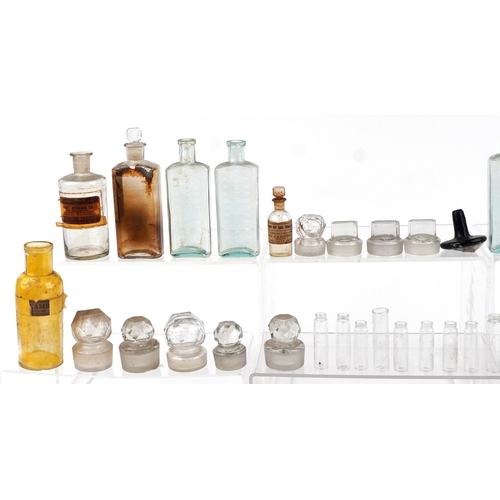 87 - A collection of early 20th century apothecary and pharmaceutical glass bottles together with decante... 