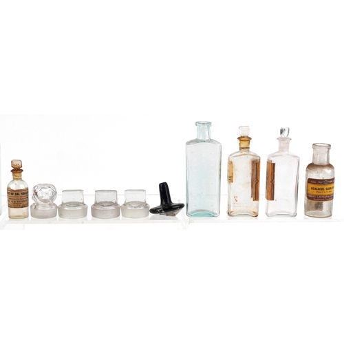 87 - A collection of early 20th century apothecary and pharmaceutical glass bottles together with decante... 