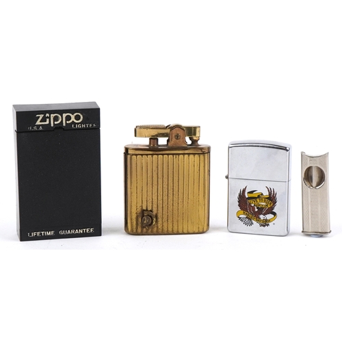 101 - Smoking items comprising a Zippo Harley Davidson lighter, a brass musical lighter and a white metal ... 
