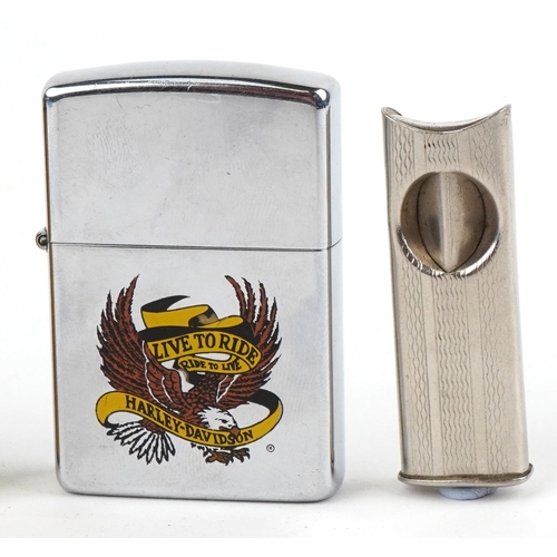 101 - Smoking items comprising a Zippo Harley Davidson lighter, a brass musical lighter and a white metal ... 