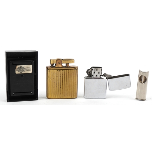 101 - Smoking items comprising a Zippo Harley Davidson lighter, a brass musical lighter and a white metal ... 