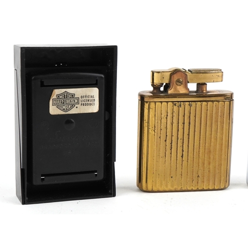 101 - Smoking items comprising a Zippo Harley Davidson lighter, a brass musical lighter and a white metal ... 