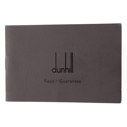 100 - A Dunhill gold plated engine turned pocket lighter with guarantee card, 6.5cm high.