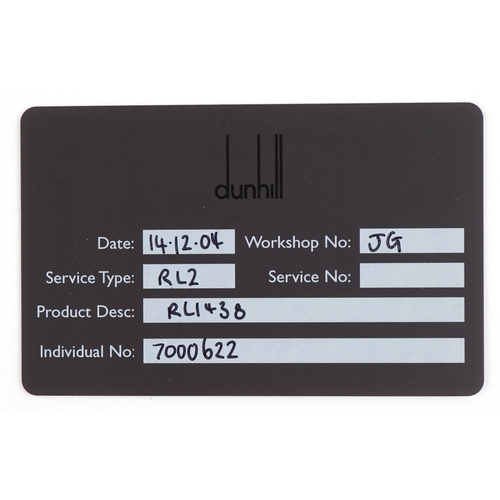 100 - A Dunhill gold plated engine turned pocket lighter with guarantee card, 6.5cm high.