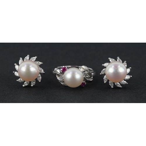 A 14K white gold cultured pearl and ruby ring with leaf design shoulders, size L, together with a pair of 14K white gold cultured pearl and diamond cluster stud earrings, 1.3cm in diameter, total 10.7g, housed in a Mikimoto Pearls jewellery box.