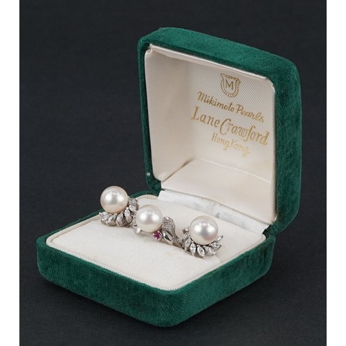  A 14K white gold cultured pearl and ruby ring with leaf design shoulders, size L, together with a pa... 