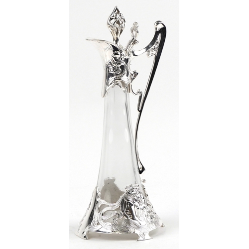 1686 - An Art Nouveau style silver plated and glass claret jug decorated with stylized flowers, 41cm high.