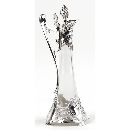 1686 - An Art Nouveau style silver plated and glass claret jug decorated with stylized flowers, 41cm high.
