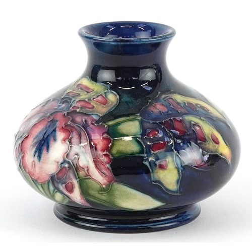 72 - Moorcroft, a hand painted Iris pattern pottery squat vase, impressed marks to the base, 7cm high.