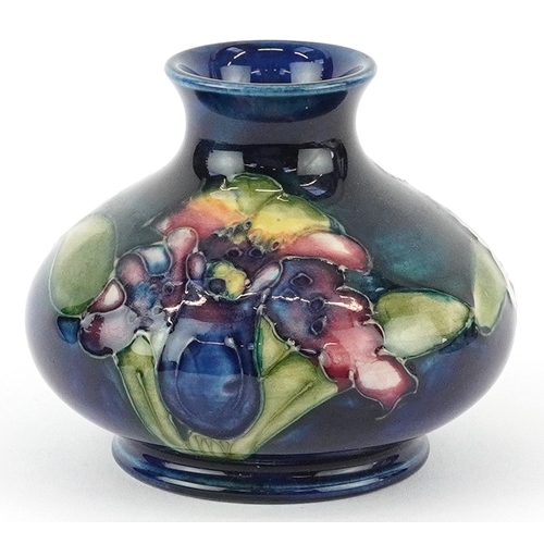 72 - Moorcroft, a hand painted Iris pattern pottery squat vase, impressed marks to the base, 7cm high.