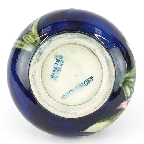 72 - Moorcroft, a hand painted Iris pattern pottery squat vase, impressed marks to the base, 7cm high.