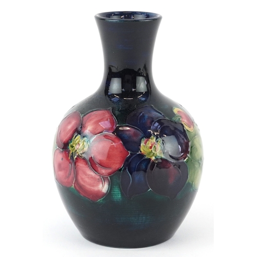 71 - Moorcroft, a hand painted Clematis pattern pottery vase, impressed marks to the base, 13cm high.