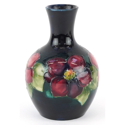 71 - Moorcroft, a hand painted Clematis pattern pottery vase, impressed marks to the base, 13cm high.
