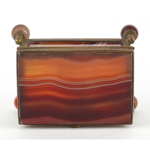 39 - An antique agate and brass jewel box raised on four ball feet, 4.5cm high x 6.5cm wide.