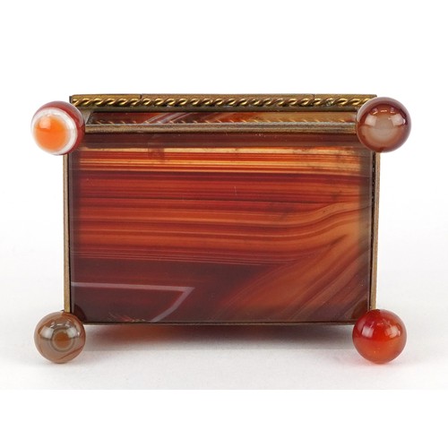 39 - An antique agate and brass jewel box raised on four ball feet, 4.5cm high x 6.5cm wide.