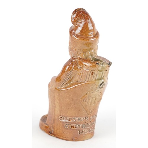 30 - A Victorian salt glazed stoneware inkwell modelled as a seated Mr. Punch, impressed For Gardner's In... 